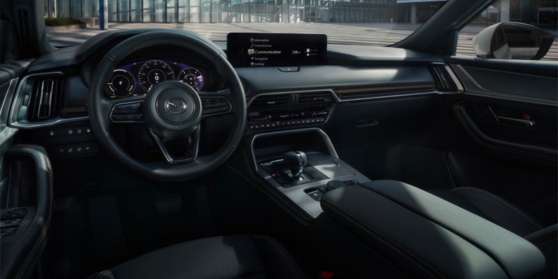 Front cabin view of a Mazda CX-90 showing the dashboard, steering wheel