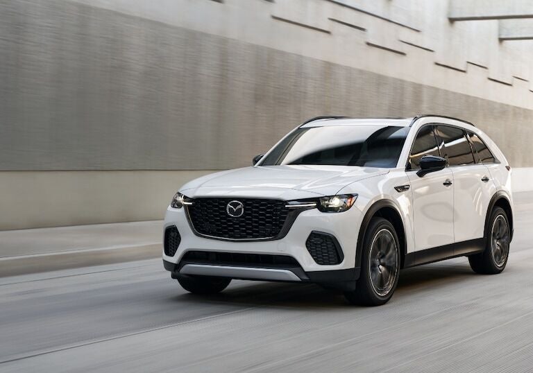 White Mazda CX-70 driving down a road towards the camera