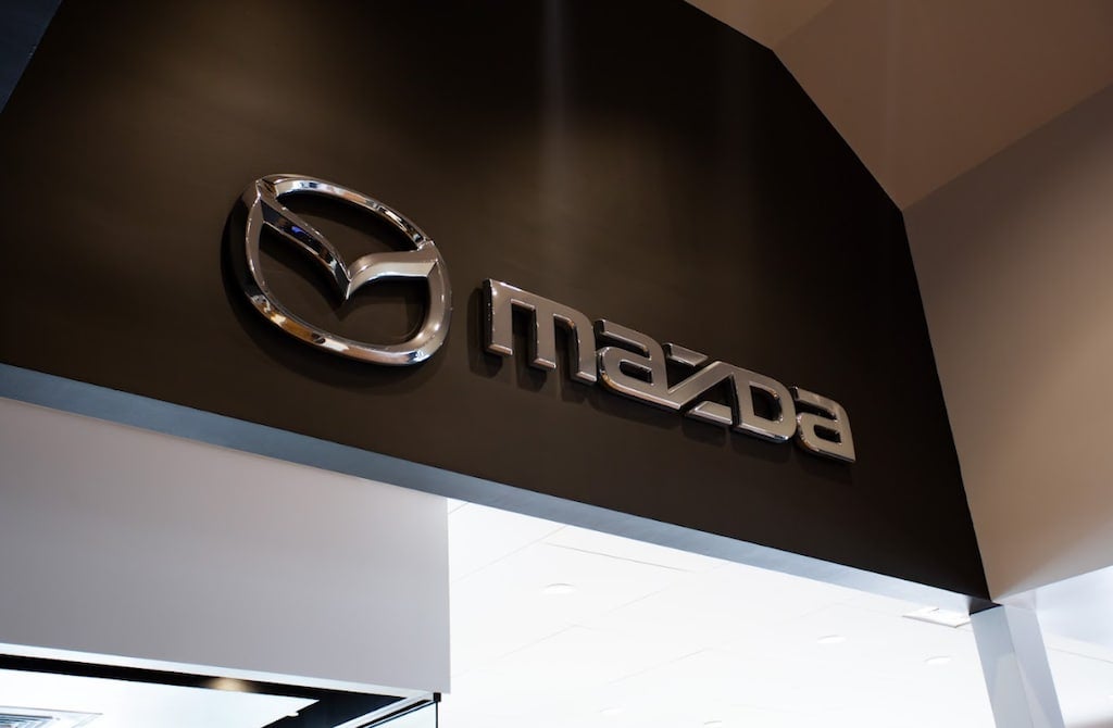 Mazda logo on the interior wall of the Flow Mazda of Fayetteville dealership in Carolina