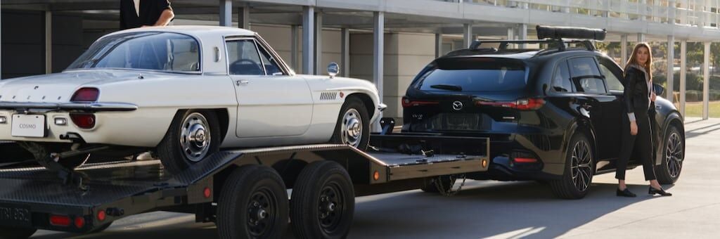 2025 Mazda CX-90 towing a white sports car